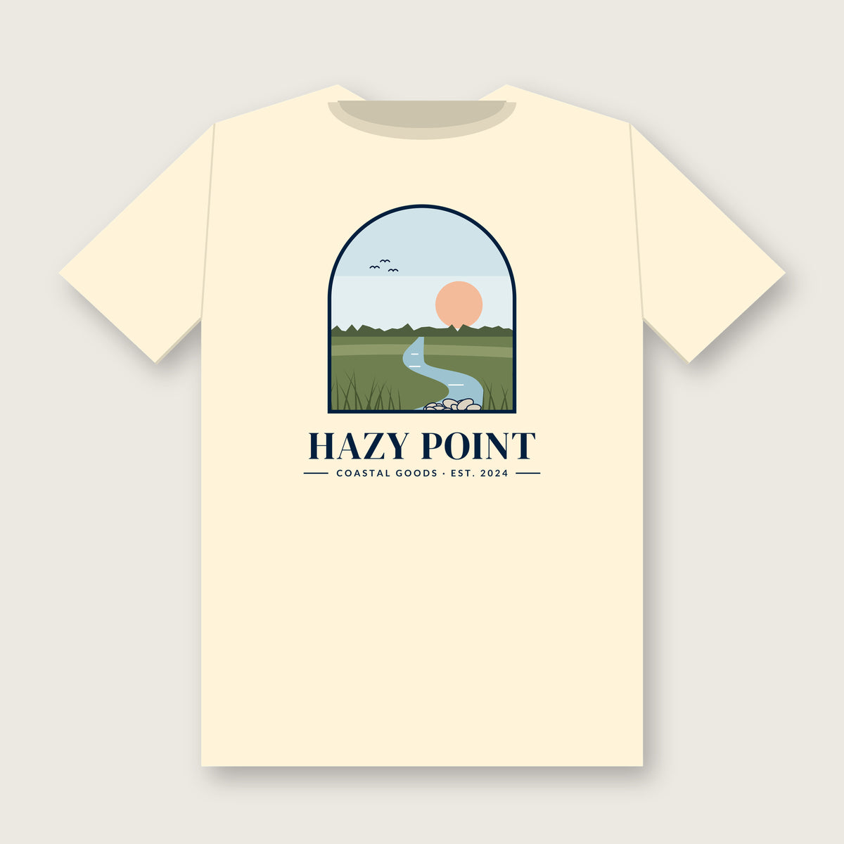 Back of the ivory Hazy Point Spartina Window Tee: an arched window looking onto spartina marsh grass, a winding tidal creek and a low sun, above the HAZY POINT wordmark and EST. 2024