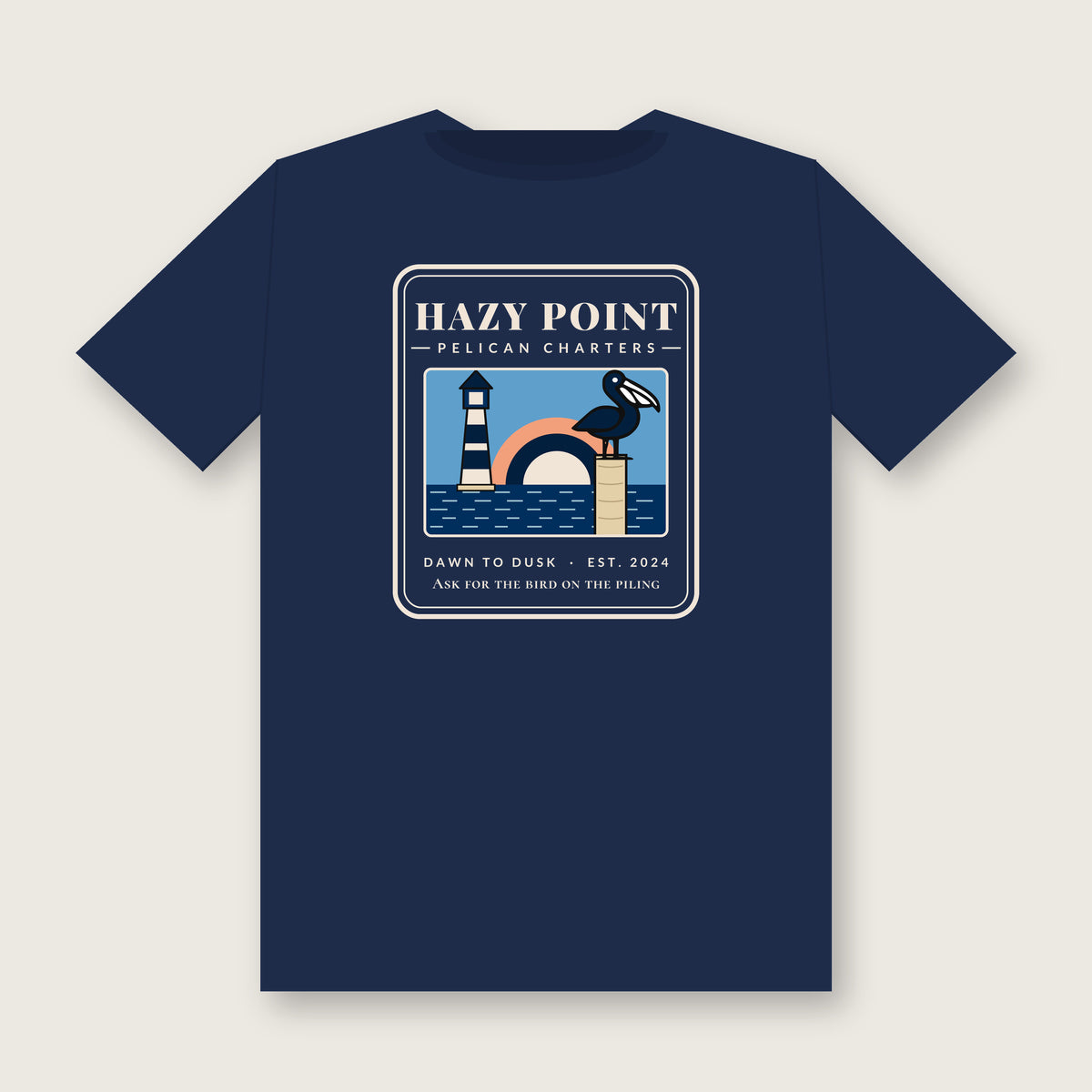 Back of the true navy Hazy Point Pelican Charters Tee: a pelican on a piling beside a striped lighthouse under an arc of sunrise, captioned like a charter office sign