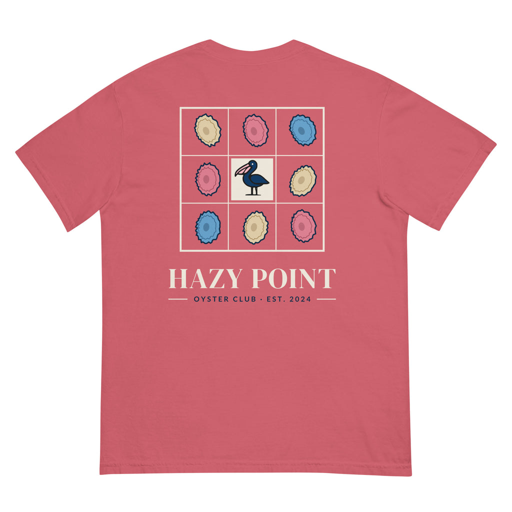Back of the watermelon-pink Hazy Point Oyster Club Tee: a grid of eight sand, rose and sky oyster shells around a pelican, with HAZY POINT and EST. 2024 beneath